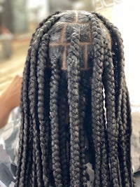 the back of a woman's hair with braids in it